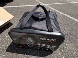 a bag that is sitting on the ground next to a car