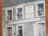an old photo of a couple of people standing in front of a building
