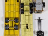 a yellow toy truck that is sitting next to other toy vehicles