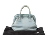 an image of a blue handbag on a black bag