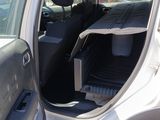 a car with the door open and a broom in the passenger seat