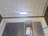 a small freezer that is open and has a bag of food inside of it