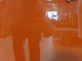 a person taking a picture of a person standing in a room