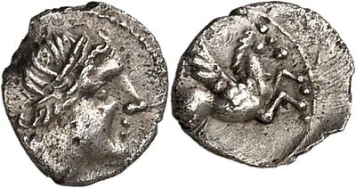 a silver coin with an image of a horse and a bird on it