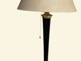 a lamp that is on a table with a white shade