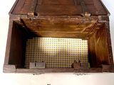 a small wooden box with a key inside of it