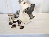 a microscope on a table with a cup of coffee and a pair of sunglasses
