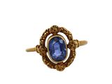 a close up of a gold ring with a blue stone