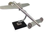 a silver model of a plane on a black base