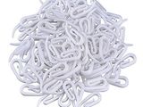 a pile of white plastic clamps on a white surface