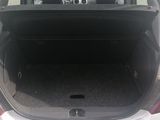 a trunk of a white car with the back door open