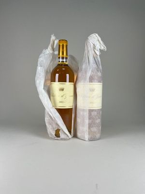 two bottles of wine sitting next to each other on a table