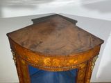 a corner table with a glass door in the corner