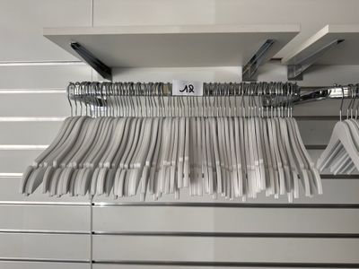 beaucoup de vêtements suspendus à une étagère dans un magasin