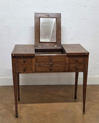 a small wooden table with a mirror on top of it