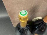 two bottles of wine sitting next to a cardboard box