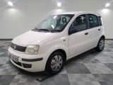 a picture of a small white car parked in a garage