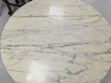 a marble table with four chairs around it