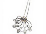 a close up of a silver necklace with an octopus on it