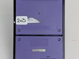 a close up of a purple nintendo game console sitting on top of a white table