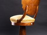 a wooden chair with a yellow seat and a wooden armrest
