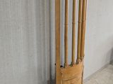a tall wooden door leaning against a wall in a room