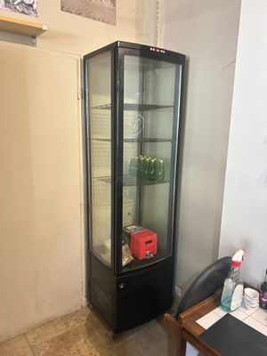 a glass display case in the corner of a room