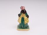 an image of a figurine of a woman in a yellow dress