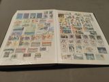 an open book with stamps on it sitting on a table
