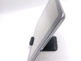 a tablet computer sitting on a stand on a white surface