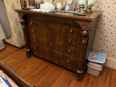 a dresser with a mirror on top of it in a room
