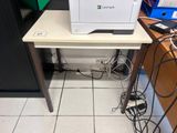 a printer sitting on top of a desk in an office