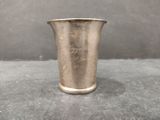 a silver cup that is sitting on a table