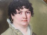 portrait of a woman in a green coat and white shirt
