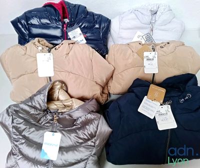 four jackets and two jackets with tags on them