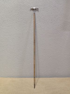 a hammer that is sitting on a table next to a wall
