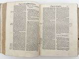 an open book on a table with a white background