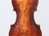 an old violin with a wooden back and a brown body