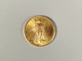an image of a gold coin with the image of a saint gaudet on it