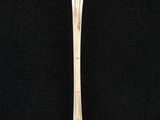 silver spoon on a black surface with a black background