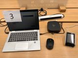 a laptop, mouse, cell phone, and other electronics on a table