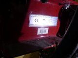 a close up of a red vehicle with a barcode on it