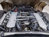 a close up of a car engine with its hood open