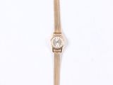 an image of a gold wrist watch with a diamond on the face