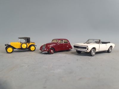 three toy cars sitting next to each other on a table