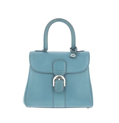 a blue leather handbag with a metal handle on a white background