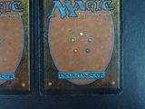 pair of magic the gathering deck boxes on a black surface