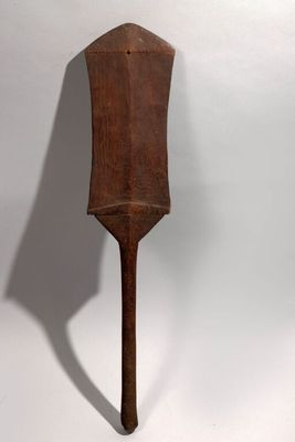 an old wooden spatula on a white background with a shadow