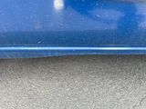 a close up of a car ' s bumper with a cat on it