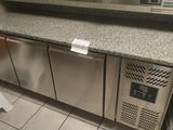 a stainless steel counter top with a microwave on top of it